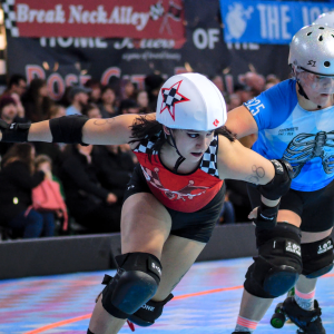 a roller derby skater with a star on their helmet passes another skater